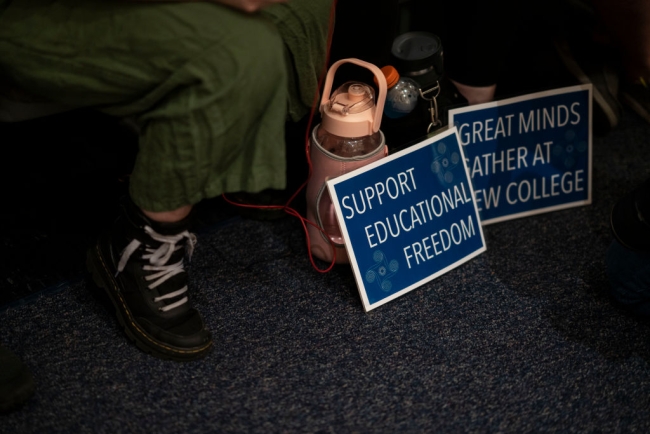 Student signs for "educational freedom" at New College of Florida.